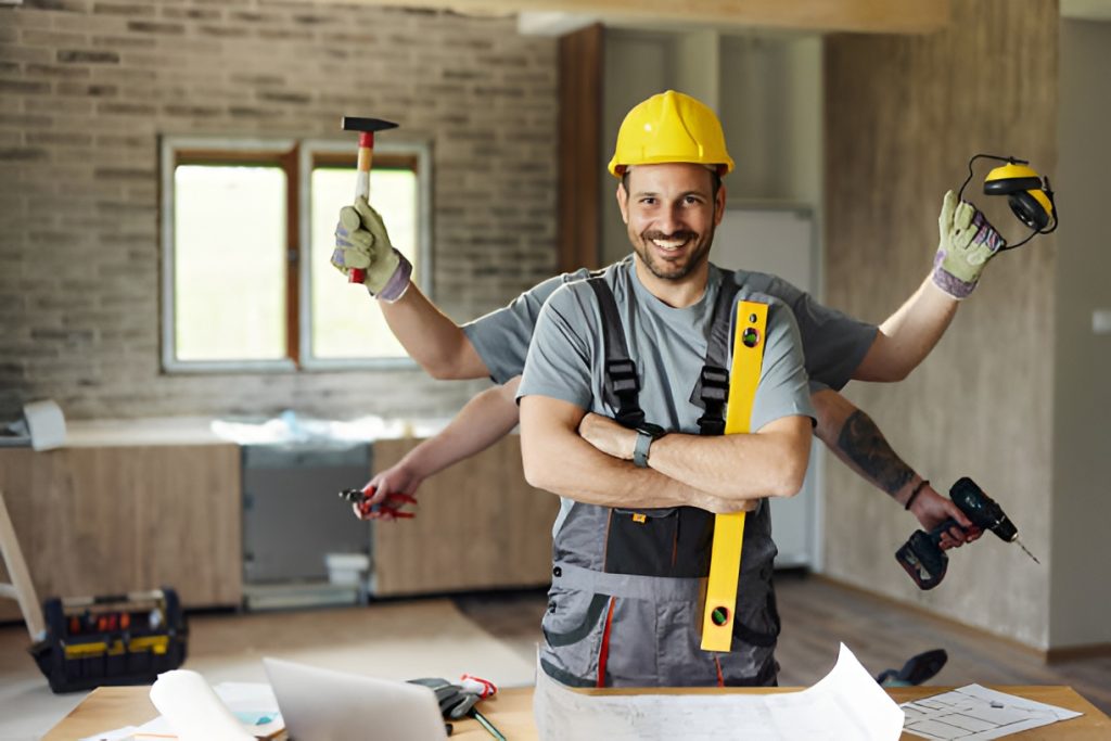man wearing a yellow hard hat holding carpentry tools